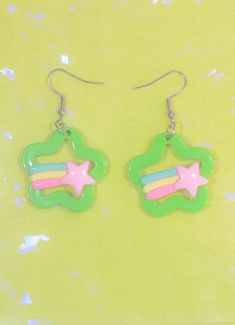 Add an extra element of cute to any outfit with the beautiful, rainbow-studded Kawaii Star Earrings from In Control Clothing’s women’s clothing boutique. These fashion accessories are constructed to mirror the outline of a flower, with a three-strip rainbow shooting star on full display in the middle. Find the right color that best matches your style and shop all our other women’s boutique collections! Kawaii Star Earrings Highlights: Features gorgeous, three-strip rainbow and a bright yellow sh Dopamine Jewelry, Shrink Art, Harajuku Outfits, Fall Plaid, Boutique Collection, Product Ideas, Shooting Star, Beautiful Rainbow, Autumn Theme