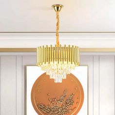 a chandelier hanging from the ceiling in a room with white walls and wood paneling