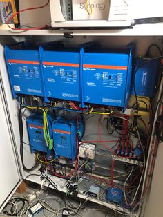 the inside of an electrical cabinet with many wires and other electronic equipment connected to it