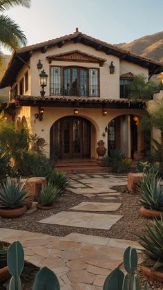 a large house with lots of plants in the front yard and walkway leading up to it