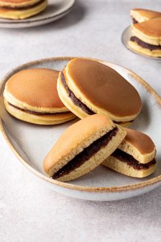 some cookies are sitting on a plate and one is cut in half