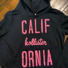 Never Worn! Navy With Glitter Pink Writing! Smoke Free Home! Bundles Welcome! Casual Long Sleeve Sweatshirt With Glitter Print, Casual Glitter Print Long Sleeve Sweatshirt, Casual Glitter Print Tops For Spring, Casual Long Sleeve Glitter Print Sweatshirt, Casual Tops With Glitter Print For Streetwear, Pink Casual Top With Glitter Print, Casual Pink Tops With Glitter Print, Pink Cropped Hoodie, Hollister Sweatshirt