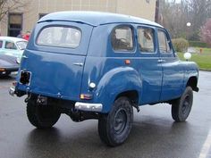 an old blue pick up truck parked in a parking lot