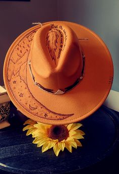 Custom burned wide brim fedora with tons of added features! This beauty reminds you of those starry nights out in the wilderness. It is available in a one size for most felt fedora or a fit to size wool hat. All hats have an adjustable ribbon on the inside of the hat. Each hat is made to order and recreated each time there is a purchase. Hat maybe slightly darker in person due to Camara flash. Winter Festival Fedora With Curved Brim, Bohemian Fedora For Western-themed Winter Events, Curved Brim Felt Hat For Fall Festival, Embellished Hats, Diy Hats, Hat Burning, Starry Nights, Wide Brim Fedora, Felt Fedora