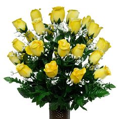 a vase filled with yellow roses and greenery