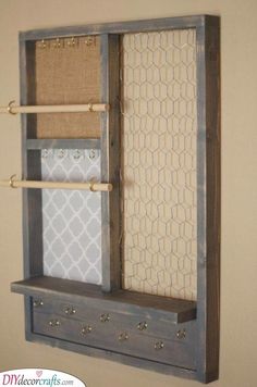 a shelf that has some fabric on it and two wooden pegs hanging from the wall