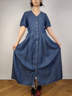 DESCRIPTION The Dark Blue Maxi Denim Shirt Dress is a beautiful vintage long dress in a soft dark denim fabric. CONDITION This dress is in great vintage condition SIZING This vintage dress is estimated as a size S > please check measurements below as all vintage sizes are different. Model is size XS and is 1m65 MEASUREMENTS  Arms till shoulder seam: 25cm Shoulder till shoulder seam: 38cm Armpit to armpit: 46cm Waist: 40cm Length: 126m MATERIAL 100% cotton  Light and smooth denim fabric BRAND Tencel WITH LOVE  All vintage fashion for women are washed/cared for and shipped from Berlin with a lot of love All vintage clothing are one of a kind and might have some small imperfections. The clear flaws will be written under condition. By Jenny from The Vintage Takeaway Summer Indigo Denim Dress With Buttons, Indigo Denim Short Sleeve Dress With Pockets, Indigo Denim Dress With Pockets And Short Sleeves, Indigo Short Sleeve Denim Dress, Short Sleeve Washed Blue Dress With Buttons, Washed Blue Short Sleeve Dress With Buttons, Dark Wash Short Sleeve Dress With Buttons, Vintage Short Sleeve Denim Dress With Pockets, Vintage Denim Blue Dress With Buttons