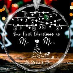 a glass ornament with the words our first christmas as mr and mrs