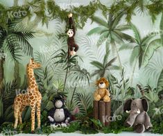 stuffed animals are hanging from the ceiling in front of a jungle scene with monkeys, giraffes and zebras