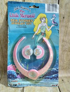 the little mermaid sea stones jewelry set is in its package, and it's pink