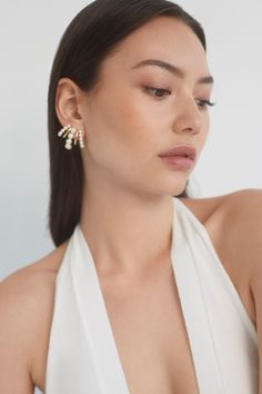 A classic style with a twist, these illusion earrings create the illusion of multiple hoops all in one for a dramatic and glamorous look. Perfect for adding a touch of elegance to your everyday look or making a statement on a special occasion. Chic Pearl Drop Clip-on Earrings For Wedding, Glamorous White Cluster Earrings For Formal Occasions, White Elegant Ear Climbers For Anniversary, Elegant White Ear Climbers For Anniversary, Glamorous White Clip-on Earrings For Evening, Glamorous Pearl Earrings For Party, Elegant Pearl Cluster Earrings For Party, Pearl White Pearl Earrings For Evening, Chic Silver Pearl Earrings For Party