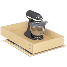 an electric mixer sitting on top of a wooden box with its lid open to show the attachment