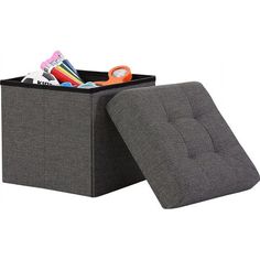 a gray storage box with scissors and other items in it