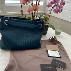 Authentic Bottega Veneta Bag. The Top Is Open To A Brown Suede Interior With Zipper And Patch Pockets. One Strap Can Be Pulled Up So The Bag Is Cinched And Become A Shoulder Bag. Comes With Pocket Mirror Leather On Back With Embossed Bottega Veneta On Back. It Is A Perfect Everyday Shoulder Bag/Tote Color Deep Aqua Base Length: 13 In Height: 10.5 In Width: 5.25 In Drop: 6 In Formal Satchel Bag With Intrecciato Weave, Designer Satchel Bag With Intrecciato Weave, Blue Handheld Shoulder Bag With Leather Handles, Designer Intrecciato Satchel Bag, Designer Intrecciato Weave Satchel Bag, Designer Handheld Shoulder Bag With Intrecciato Weave, High-end Blue Shoulder Bag With Removable Pouch, High-end Blue Tote Shoulder Bag, Designer Intrecciato Office Bag