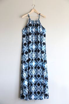 a blue and white dress hanging on a wall