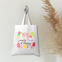 This Popsicle Every Flavor of Happy 🍢🍉White Tote Bag is the ultimate mood-lifter! Perfect for any summer getaway from beach days and vacations to school trips, this colorful design bag will add a pop of fun wherever you go! This bag is a perfect way to showcase a bit of your personality! It is practical, stylish and environmentally friendly reusable. We hand press each item with love and care. 💙▸ Dimensions are approximately 15"W x 16"H with 10" handles▸ Material: Polyester canvas▸ Print: Sub Playful White Summer Bag, Playful Summer Shoulder Bag For School, Playful Summer School Shoulder Bag, White Tote Shoulder Bag For Back To School, Multicolor Summer School Bag, Playful Summer School Bags, Fun Multicolor School Bags, Multicolor School Bag For Summer, Fun Rectangular School Bag