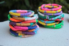 several colorful bracelets stacked on top of each other