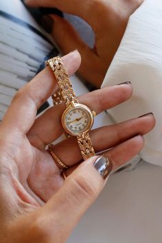 Discover timeless elegance with our stunning vintage gold watch, designed for the modern woman who appreciates classic beauty. With a case diameter of 20-25 mm, this small watch is the perfect size to make a stylish statement without overwhelming your wrist. Crafted from durable metal, both in the case material and the band material, this womens gold watch combines durability with sophistication. Its thick gold watch design exudes luxury, while the dainty watch aesthetic ensures it remains delicate and refined. This exquisite vintage watch is more than just a timepiece; it's a celebration of vintage charm. Whether you're adding to your collection or searching for the perfect accessory to elevate your outfit, this vintage womens watch is a fantastic choice. Ideal for any occasion, this gold Classic Gold Watch Women, Small Watches Women Vintage, Dainty Watches For Women, Gold Watch Design, Dainty Watches, Small Gold Watch, Womens Gold Watch, Gold Watch Vintage, Dainty Watch