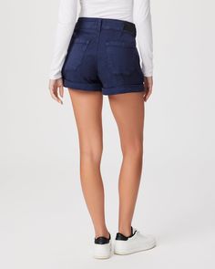 The Brooklyn Short is designed with vintage-inspired trouser pockets with stitching details, criss cross back belt loops, a wide waistband, double button closure, front pleats and a cuffed hem. This effortlessly chic short comes in a vintage navy blue hue in a super soft fabric with the perfect amount of stretch. High Rise Workwear Shorts With Belt Loops, Mid-rise Shorts With Belt Loops For Work, High Waist Bottoms With Rolled Hem, Chic Bottoms With Button Cuffs And Short Length, Trouser Pocket, Navy Shorts, Wide Waistband, Premium Denim, Blue Hues