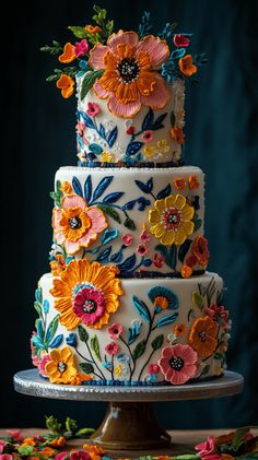 a multi - tiered cake decorated with colorful flowers