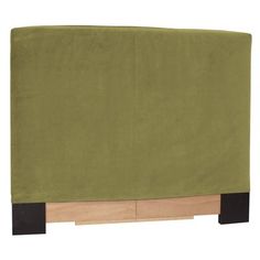 a bed with a green cover on top of it and wooden legs around the headboard