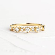 Our sparkling Eleanor ring features five 3mm and six 1.8mm natural VS quality round brilliant cut diamonds bezel set in a 14K Solid Gold mil-grain setting along with a 1.5mm band. This elegant ring is available in 14K Solid Yellow and White Gold. ✨ Features ✨ • Ships Next Day / Fedex 2 Day Service • 14K Solid Gold• Diamond Cut / Round• .65 Ctw / 11 Diamonds Total• Packaged For Gifting • Certificate Of Authenticity Included Eternity Diamond Band, Eternity Band Diamond, Elegant Ring, Bracelet Collection, Bezel Diamond, Diamond Band, Lariat Necklace, Round Brilliant Cut Diamond, Solid Yellow