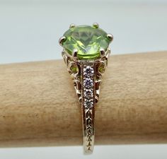 "We designed and handmade this ring. The center is a 8MM beautiful VVS Peridot 1.75 Cts . The Peridot is absolutely stunning. With 8 VS clarity side diamonds .14 Cts. It is made in 18k white gold. We can make it any size from 5-7 and you still be able to return it within the listed time frame. Sizing outside of that range makes it a FINAL SALE. We love this ring because it represents the way jewelry should be made with craftsmanship and quality. This ring is anything but ordinary. Our pieces are Classic Peridot Jewelry With Brilliant Cut, Antique Peridot Rings, Classic Peridot Green Rings, Yellow Gold Peridot Jewelry With Polished Finish, Peridot Rings With Polished Finish, Antique Style, Final Sale, Diamond Engagement, Vintage Antiques