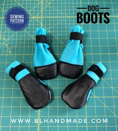 four blue and black dog boots sitting on top of a cutting board