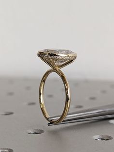 a diamond ring sitting on top of a table