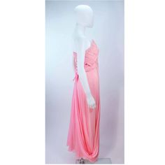 Description: Arnold Scaasi pink draped chiffon gown The bodice has a criss-cross design The skirt features a drape style Center back zipper closure with bow accent In very good condition with some minor fading Length: 52.5" Bust: 31" Waist: 28" Hip: 38" Details: Size: 4/6Color: PinkMaterial: ChiffonCondition: Very GoodShipping: All orders are shipped with a standard flat rate of $9.95 or expedited flat rate of $19.95. Pink Pre-draped Evening Gown, Pre-draped Pink Evening Gown, Pink Pre-draped Floor-length Evening Dress, Pink Pre-draped Gown With Ruched Bodice, Pink Pre-draped Gown With Fitted Bodice, Pink Floor-length Evening Dress With Sheer Details, Pink Sheer Evening Dress For Prom, Pink Floor-length Sheer Evening Dress, Pink Sheer Floor-length Evening Dress