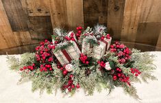 a christmas centerpiece with red berries and greenery