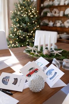 a table with christmas cards and candles on it