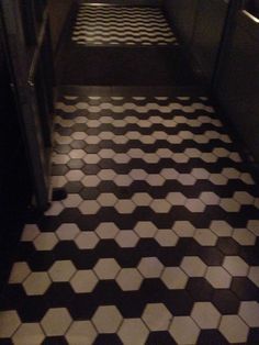 a black and white tiled floor in a bathroom