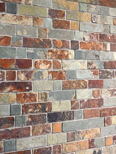 an old brick wall with many different colored bricks