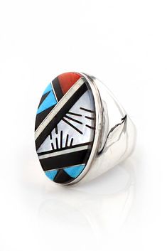 This Men's Oval Inlay Zuni Ring is created in a mosaic inlay style. The Zuni Indians of New Mexico are known for their impeccable stone inlay. This sterling silver ring features a classic design with the four traditional stones used by the Zuni Indians which are Turquoise, Red Coral, White Mother of Pearl and Black Jet. This handsome ring rests comfortably on the hand and has a distinctive yet traditional look. A great ring for the three center fingers. Hallmarked and stamped "Sterling". Size 11 Mosaic Inlay, Black Jet, Zuni Jewelry, Silver Eagle, Silver Eagles, Stone Inlay, White Turquoise, Size 10 Rings, Native American Jewelry