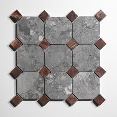 a marble tile with brown and white squares on it's sides, in the shape of hexagonals