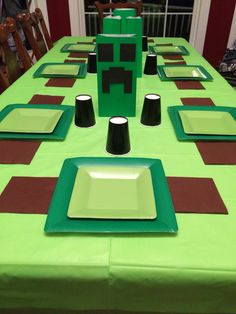 a green table topped with plates and cups