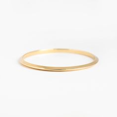 This triangular-shaped wire makes a beautiful "knife-edge" bangle. This subtle pointed shape adds dimension and shine. A 4mm x 3.5mm solid 14k gold bangle. Minimalist Gold Hoop Bracelet, Minimalist Stackable Hoop Bangle, Minimalist Stackable Gold Bracelet For Formal Occasions, Minimalist Stackable Round Bangle, Minimalist 14k Gold Hoop Bangle, Minimalist Polished Bangle, Minimalist Yellow Gold Hoop Bracelet, Minimalist Hoop Bangle In Yellow Gold, Minimalist Gold Bracelet With Smooth Bezel