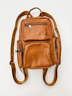 Get ready to elevate your style with the Reese Multi-Way Sling/Backpack! Available in both camel and black, this versatile bag boasts 9 spacious pockets for all your essentials. Stay on trend while staying organized - this fashionable and useful bag has got you covered. Casual Leather Travel Backpack With Cell Phone Pocket, Casual Leather Backpack With Cell Phone Pocket For Travel, Versatile Leather Backpack With Cell Phone Pocket For Everyday, Versatile Leather Backpack With Cell Phone Pocket, Versatile Leather Backpack With Anti-theft Pocket For Everyday, Versatile Brown Backpack With Zipper Pocket, Everyday Crossbody Backpack With Anti-theft Pocket, Brown Backpack With Cell Phone Pocket For On-the-go, Casual Leather Backpack With Cell Phone Pocket