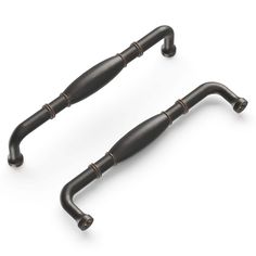 two antique style metal handles on white background