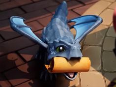 a close up of a dragon head with a piece of paper in it's mouth