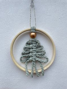 an ornament hanging on the side of a wall with a rope wrapped around it