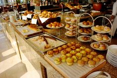 there are many different types of pastries on the counter at this restaurant that is ready to be eaten