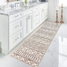 a white bathroom with two sinks and a rug on the floor in front of it