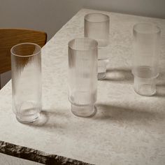 three clear glass vases sitting on top of a table