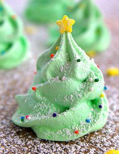 green frosted christmas tree meringues with sprinkles on the top