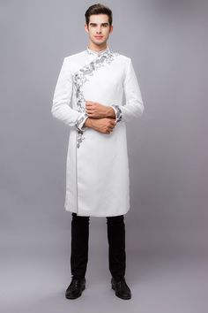 Traditional White Ao Dai For Formal Occasions, Elegant Eid Sherwani With Embroidered Sleeves, Elegant Sherwani With Embroidered Sleeves For Eid, Elegant Fitted Kurta With Embroidered Sleeves, White Ao Dai For Festive Occasions, Elegant White Ceremonial Traditional Wear, Elegant White Traditional Wear For Ceremonial Occasions, Elegant Embroidered White Sherwani, Elegant White Embroidered Sherwani