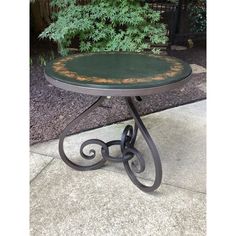 an outdoor table that has been painted green and rusted with yellow paint on it