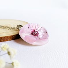 This cherry flower necklace is made from a real cherry flower picked up from the place where I live. A unique sakura necklace as the most unique birthday gift idea for women. In general, a cherry flower necklace (japanese flower necklace) is an outstanding full of significance complement for you. This sakura blossom necklace is part of my pale pink jewelry. The hypoallergenic stainless steel and the high-gloss crystalline resin gives this cherry flower necklace a precious and enamelled look. Use Sakura Necklace, Birthday Gift Ideas For Women, Necklace Japanese, Cherry Blossom Ring, Cherry Blossom Necklace, Cherry Flower, Japanese Flower, Pressed Flower Necklace, Tiny Bow