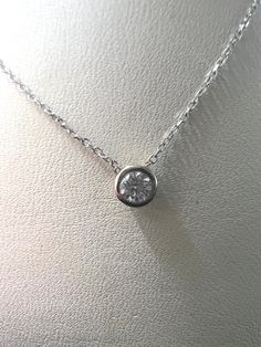 This exquisite diamond pendant necklace is the perfect way to add a touch of luxury to your look. Crafted with 14KT white gold and showcasing a sparkling .15 carat diamond with a bezel setting, it hangs gracefully from a 16-18 inch adjustable chain. Wear it to bring a hint of elegance to any ensemble.Features:-14kt White Gold-0.15 carat Diamond-White Gold Bezel Setting-14kt White Gold Adjustable chain (16-18 in.) Luxury Adjustable Diamond Necklace, Classic Round Cut Diamond Necklace With Bezel Setting, Elegant Solitaire Pendant Necklace With Bezel Setting, Classic Platinum Diamond Necklace With Bezel Setting, Classic Pendant Diamond Necklace With Bezel Setting, White Gold Pendant Diamond Cut Necklace, White Gold Diamond Cut Pendant Necklace, White Gold Diamond Cut Pendant Diamond Necklace, Formal Necklace With Single Diamond Pendant